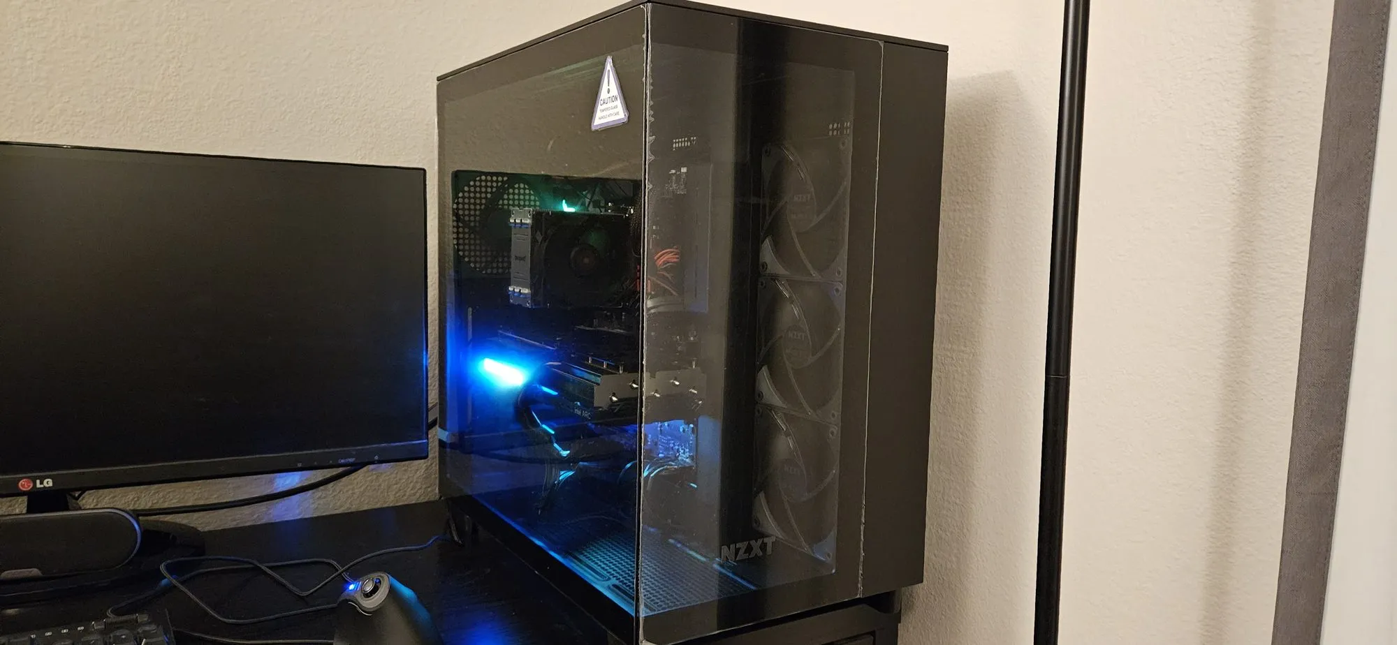 The new NZXT H9 Flow on the desk on its first night, lit blue