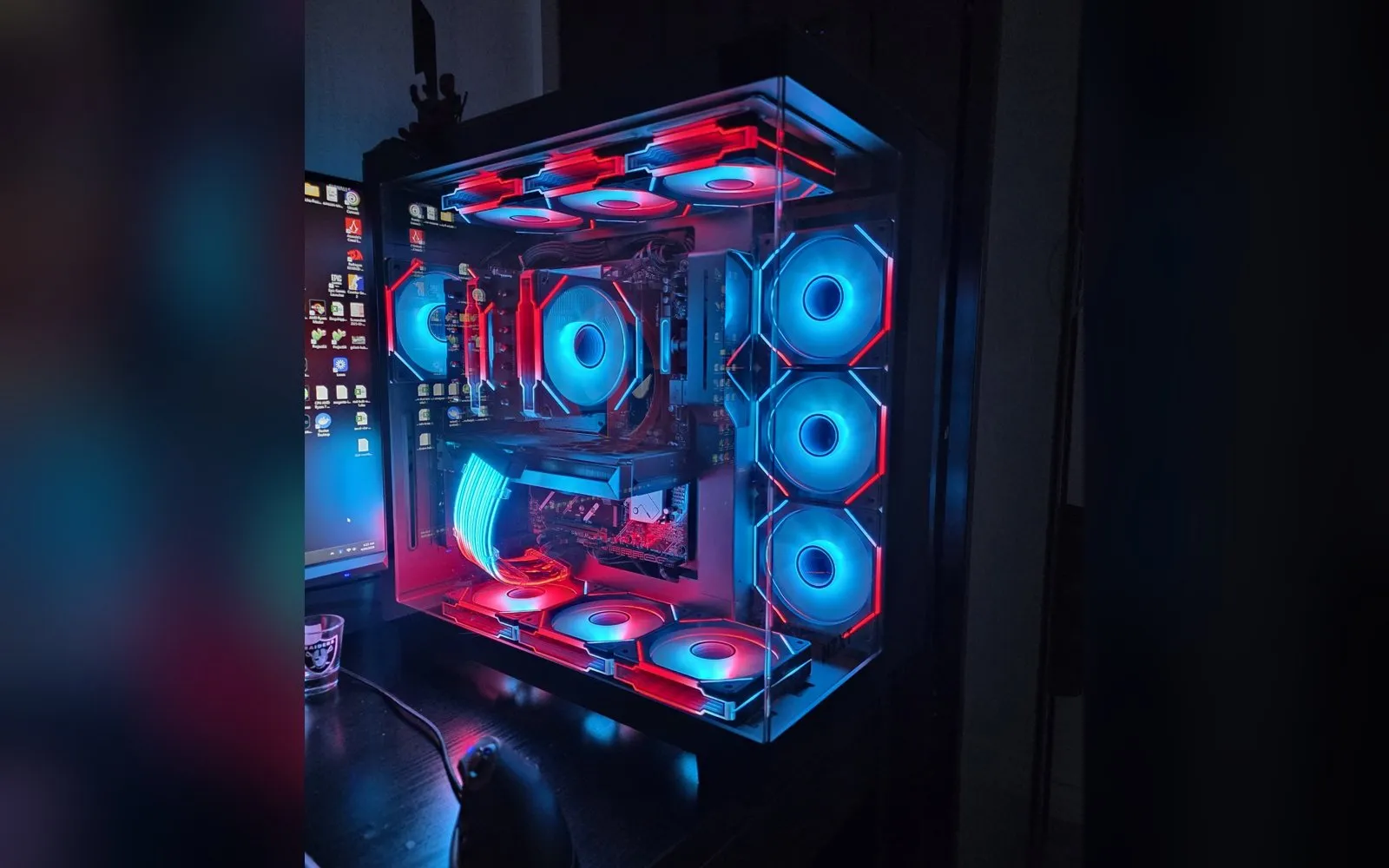 The current build with the Ryzen 5 7600X3D, lit blue and red